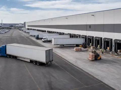 Large distribution center with multiple active loading dock doors and trailers